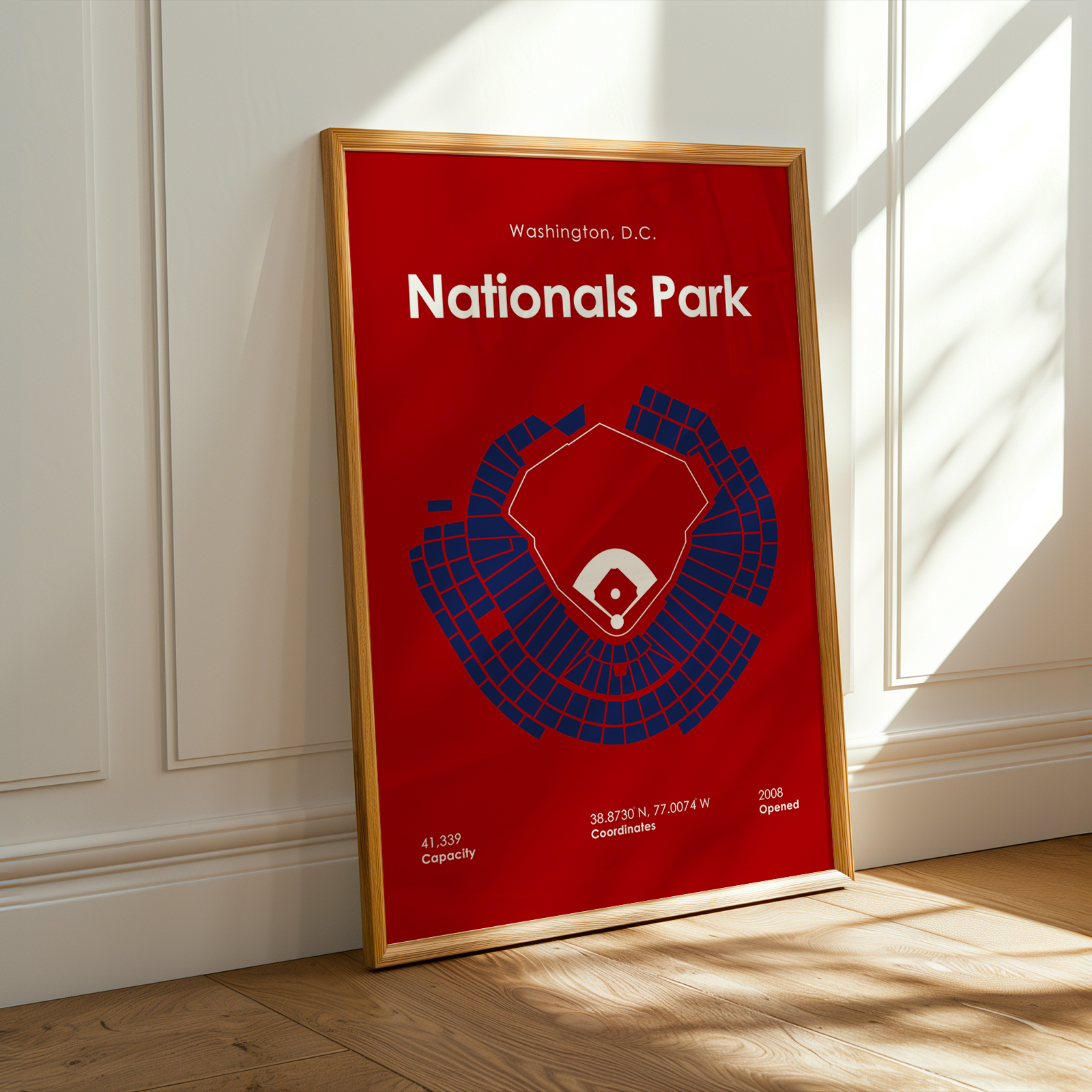 Framed poster of Nationals Park layout on a red background in a room with sunlight streaming in.