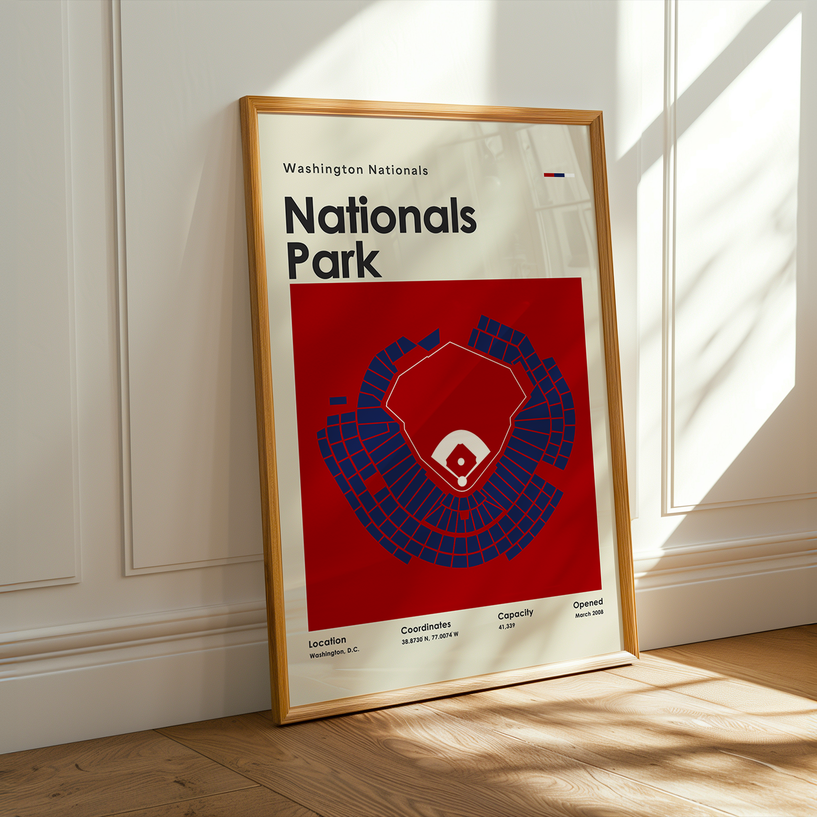 Framed poster of Washington Nationals Nationals Park with a red and blue design on a white wall.