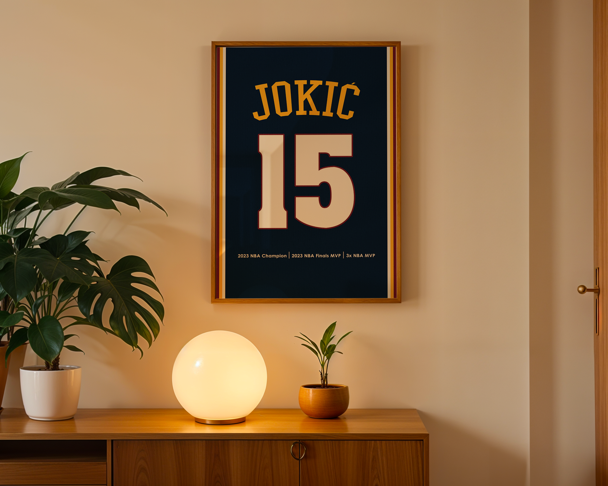 Framed poster with 'JOKIC 15' on a wall above a wooden cabinet with decorative items.