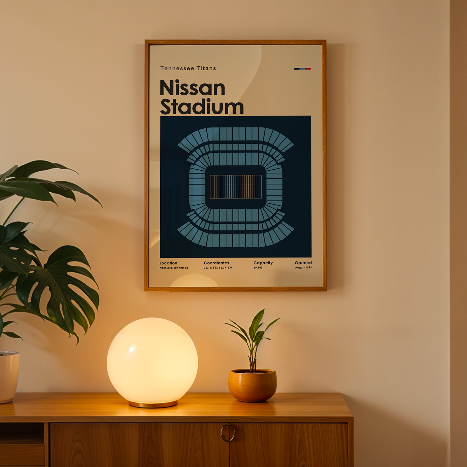 Framed poster of Nissan Stadium on a wall above a wooden cabinet with decorative items.