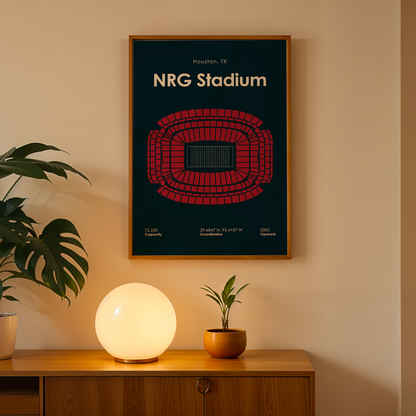 Framed poster of NRG Stadium on a wall above a wooden cabinet with decorative items.