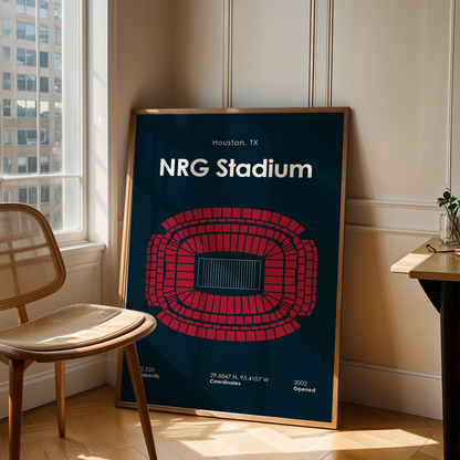 NRG Stadium map poster in a frame on a wooden floor next to a chair and table.