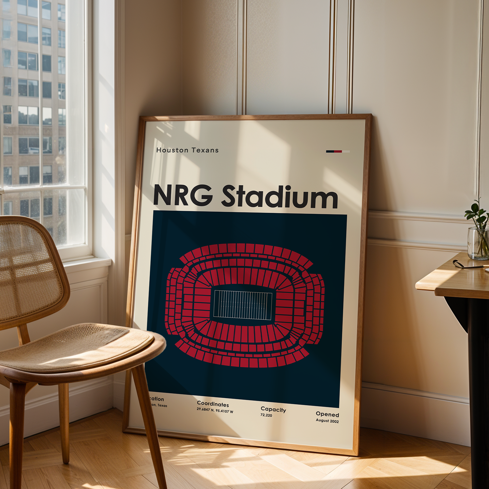 Poster of NRG Stadium in a room with a chair and table.