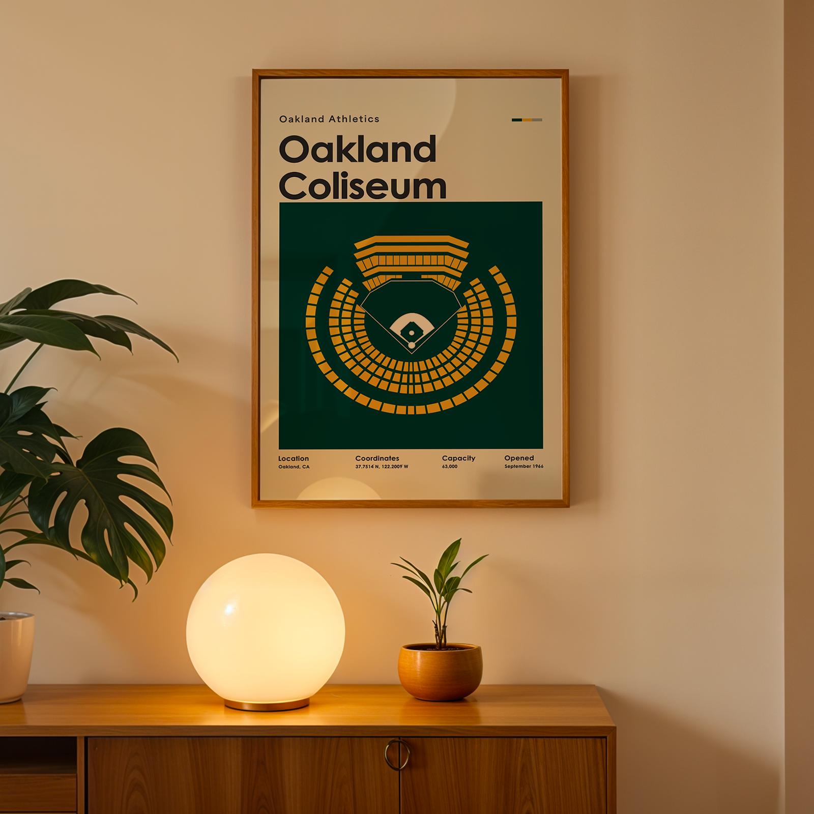 Framed poster of Oakland Coliseum on a wall above a wooden cabinet with decorative items.