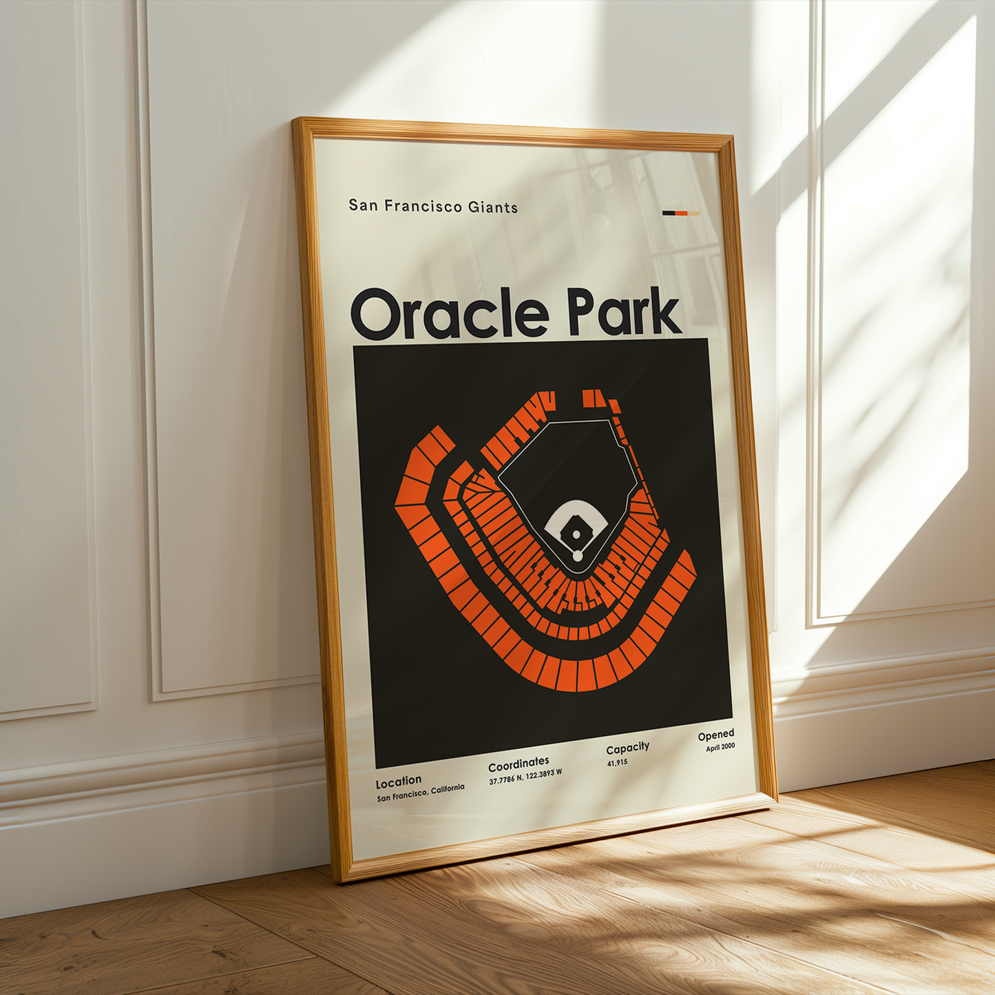 Framed poster of Oracle Park with San Francisco Giants logo on a wall.
