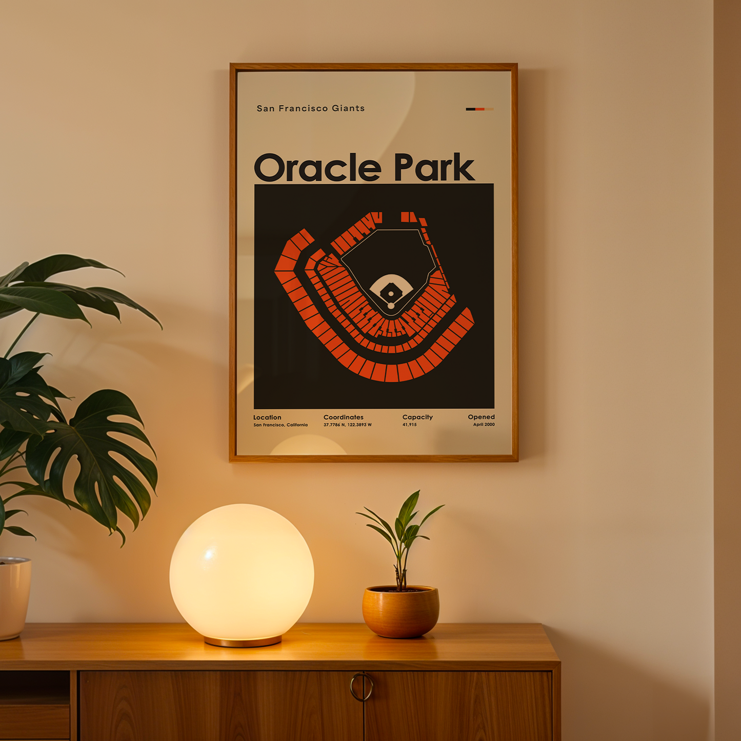 Framed 'Oracle Park' poster on a wall above a wooden cabinet with decorative items.
