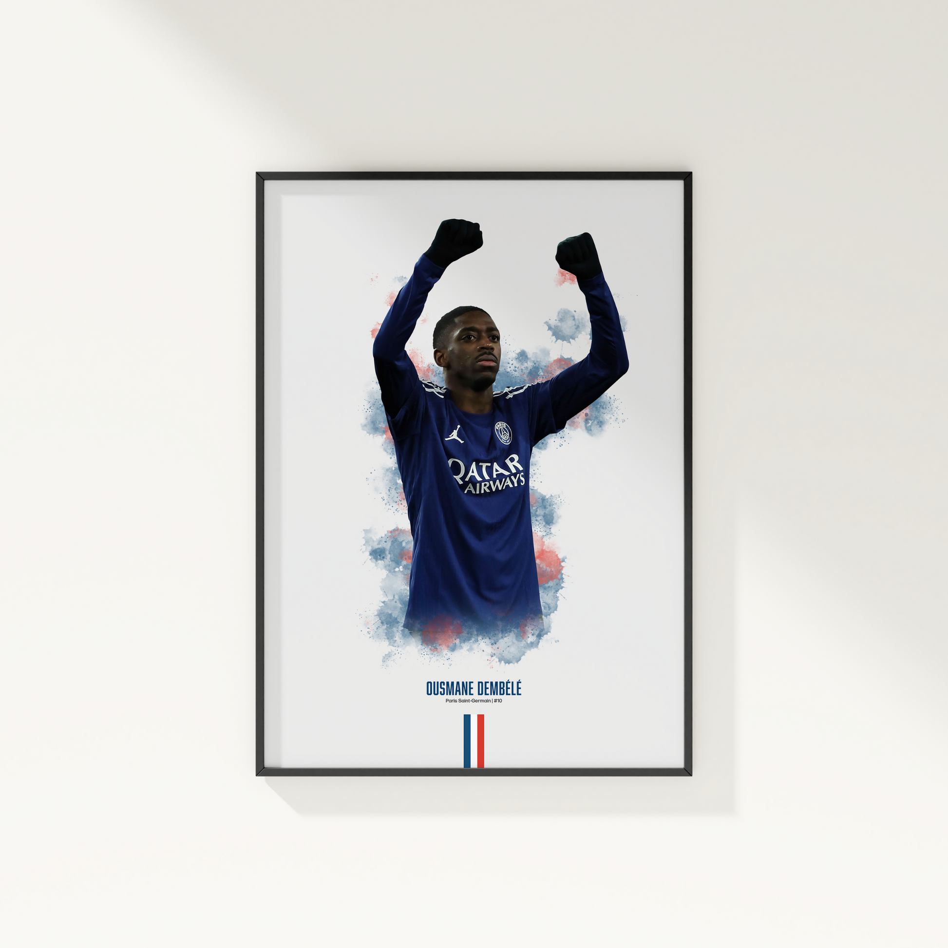 Framed poster print of soccer player Ousmane Dembele, wearing a PSG jersey, on a white wall.
