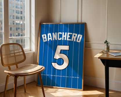Framed sports jersey with 'Banchero' and number '5' in a room with a chair and table.