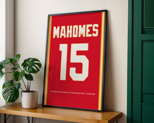 Framed sports jersey with 'Mahomes 15' on a wooden shelf.