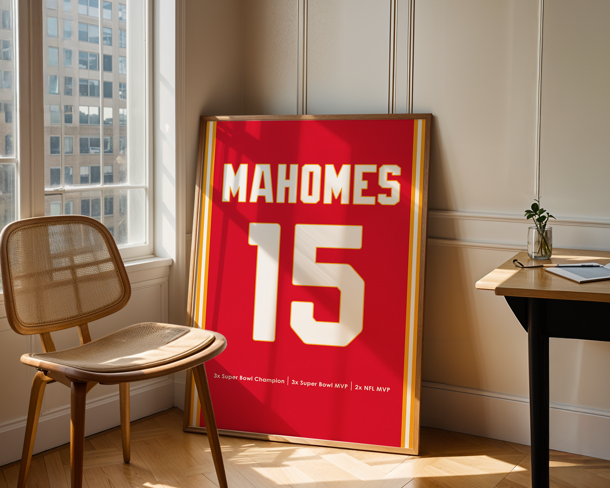 Framed sports jersey with 'Mahomes 15' on a wall in a room with a chair and table.