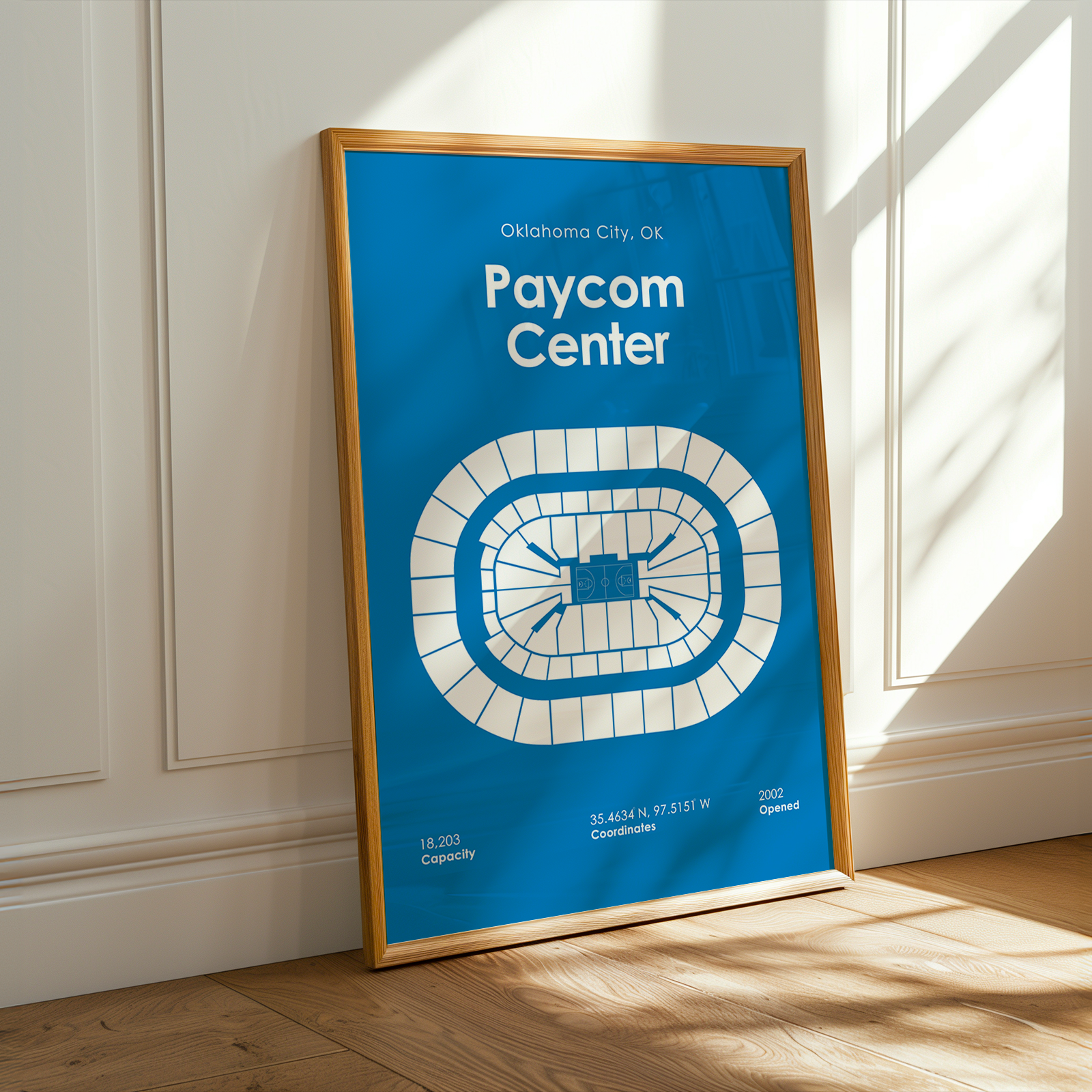 Framed poster of Paycom Center in Oklahoma City on a wall.