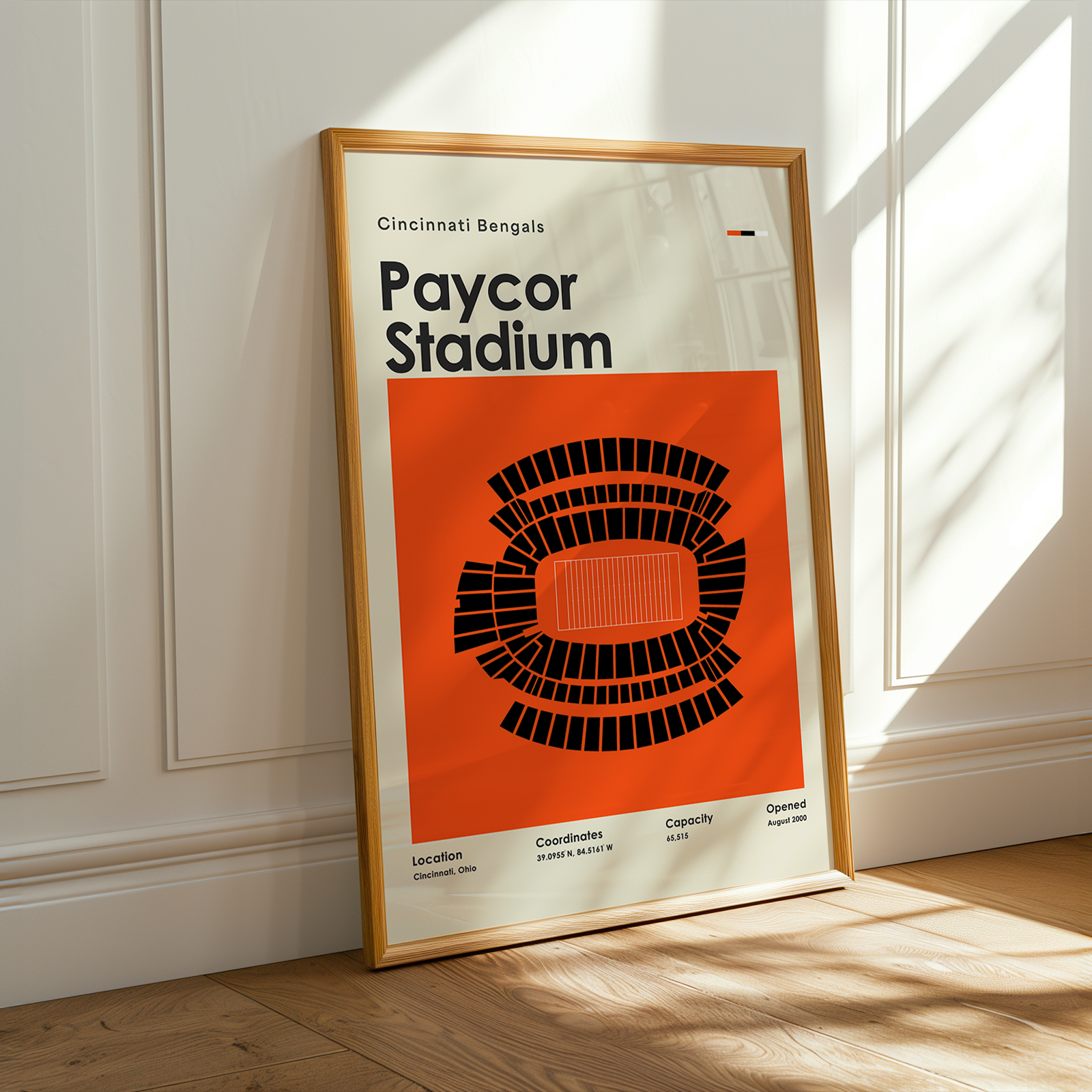 Framed poster of Paycor Stadium with a wooden frame on a light-colored wall.