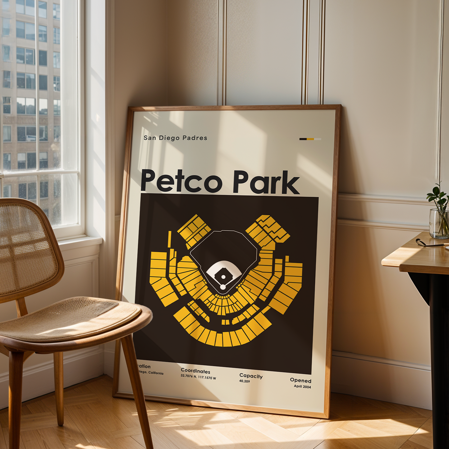 Framed Petco Park map poster in a room with a chair and table.