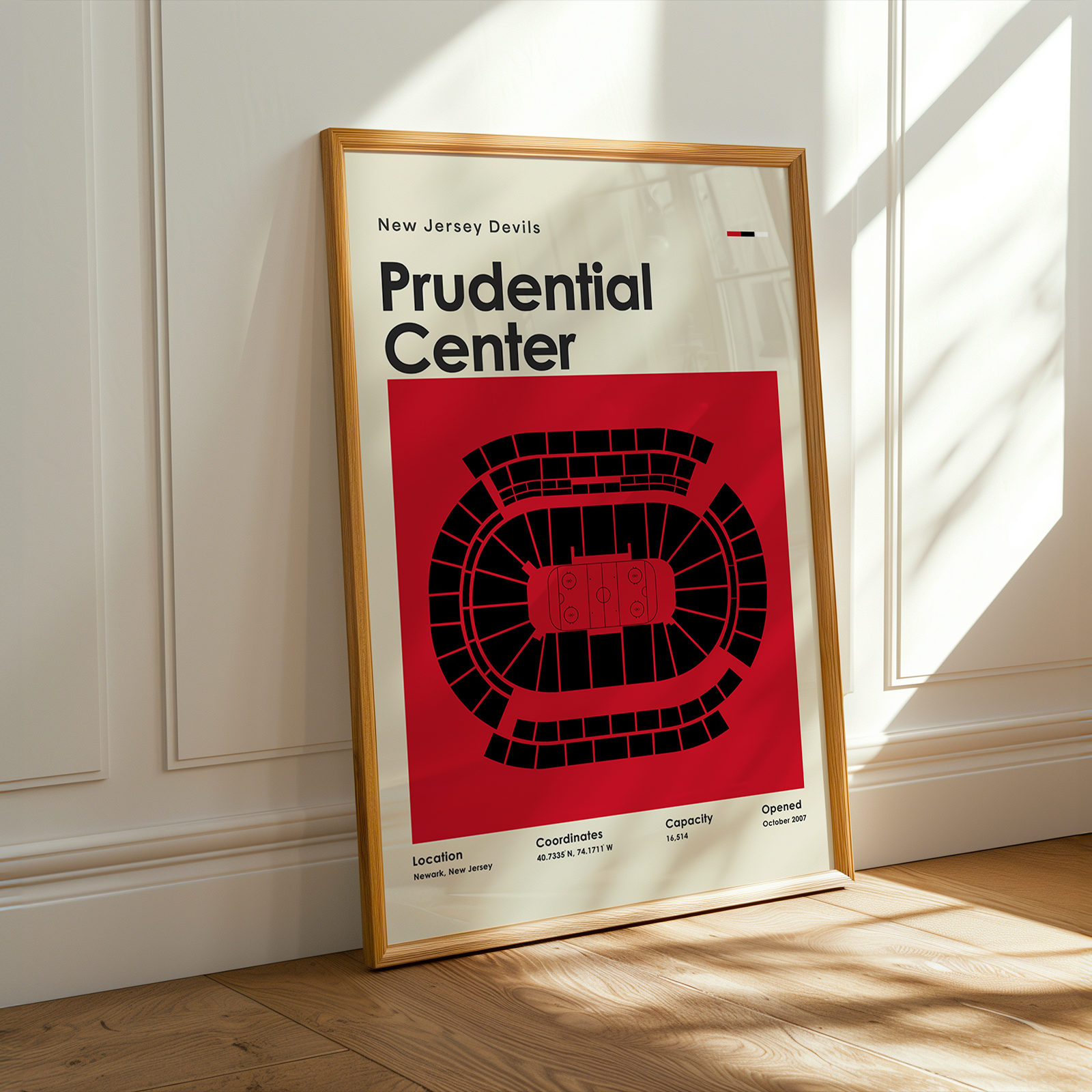 Framed poster of Prudential Center with New Jersey Devils branding on a wall.