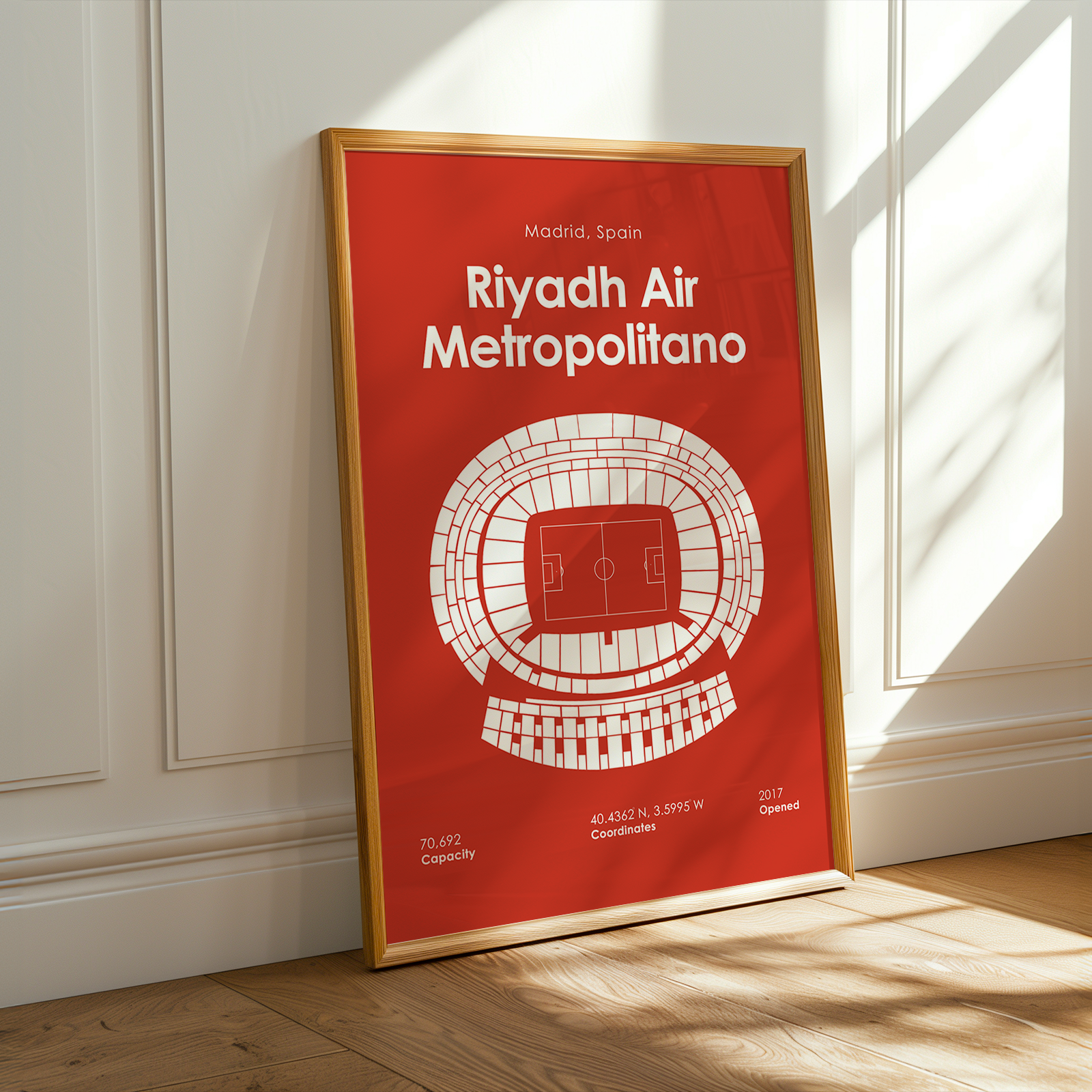 Framed poster of Riyadh Air Metropolitano on a wall with sunlight casting shadows.