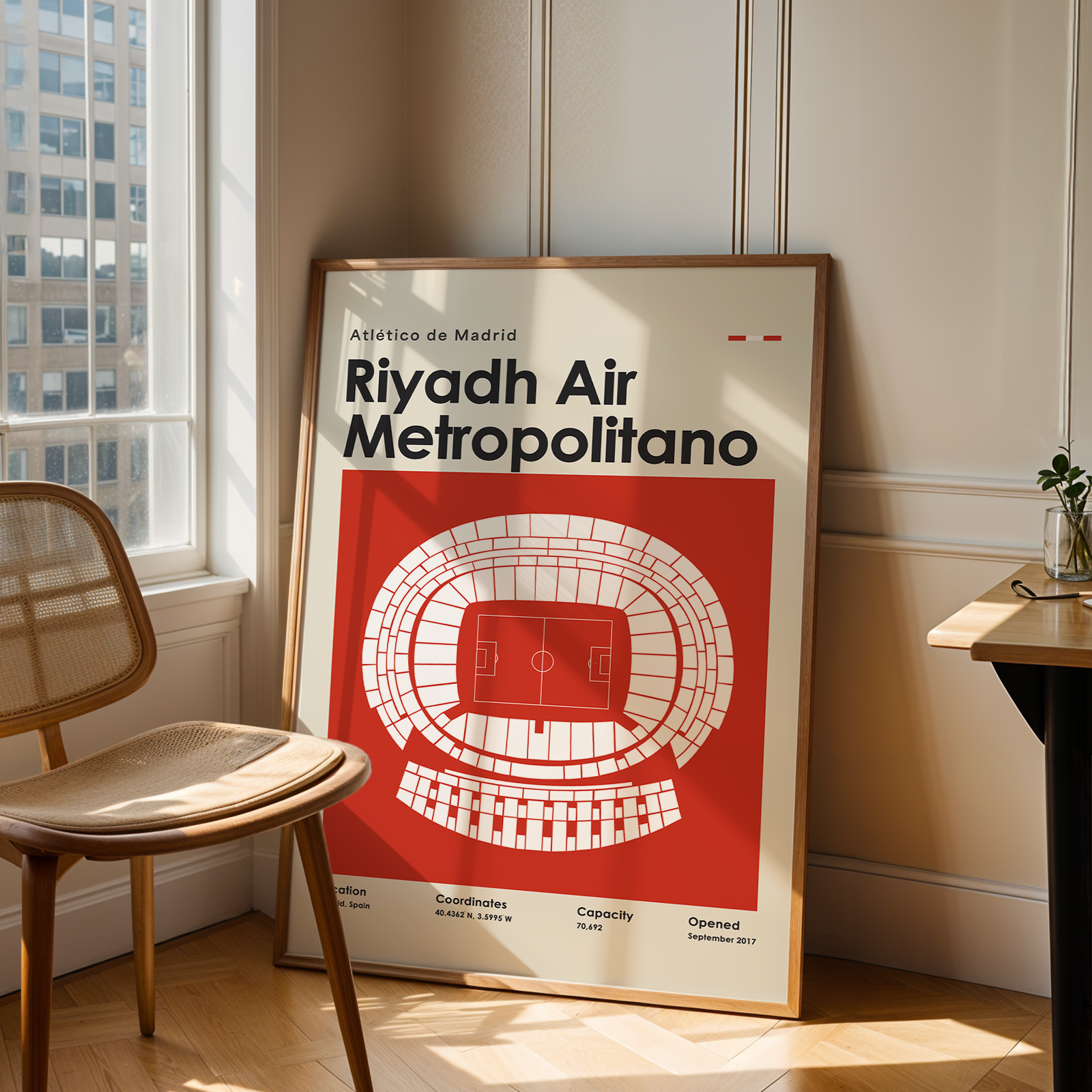 Poster of Riyadh Air Metropolitano in a room with a chair and table.