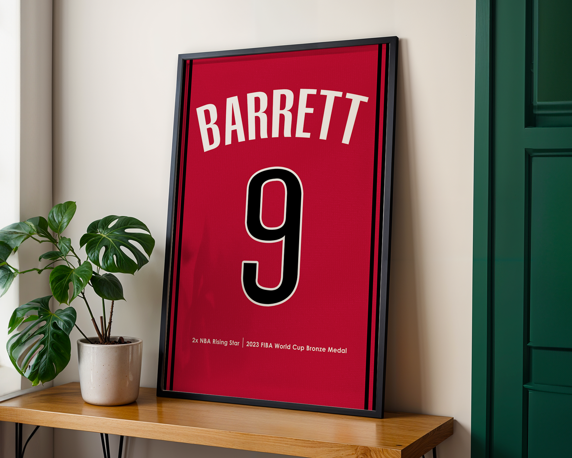 Framed sports jersey with 'Barrett' and number '9' on a wooden shelf.
