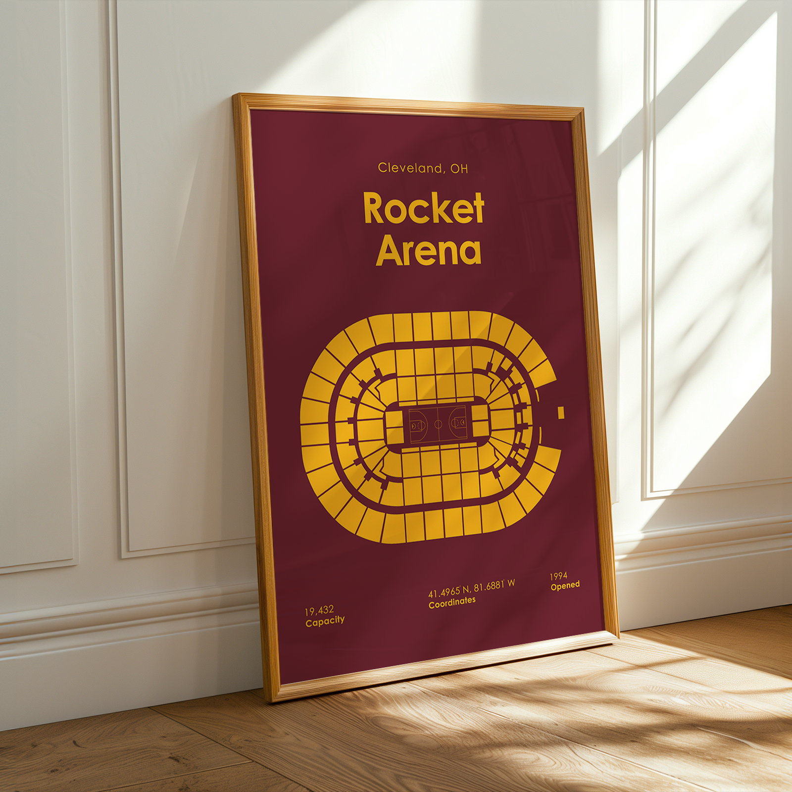 Framed poster of Rocket Arena with maroon background and yellow design, leaning against a white wall.