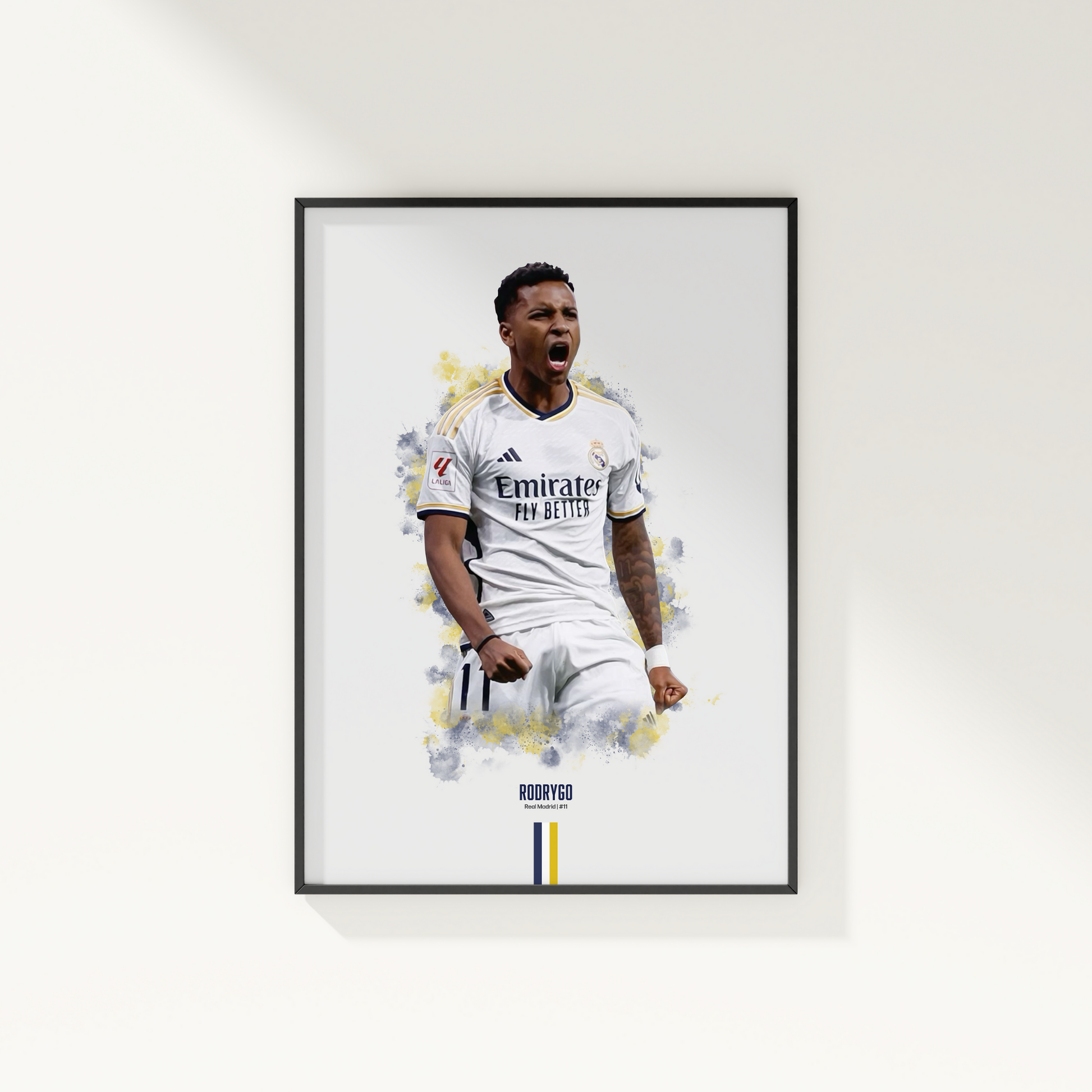 framed poster mockup of soccer player rodrygo hanging on a white wall