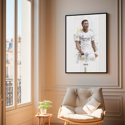 framed poster mockup of soccer player rodrygo hanging in a living room