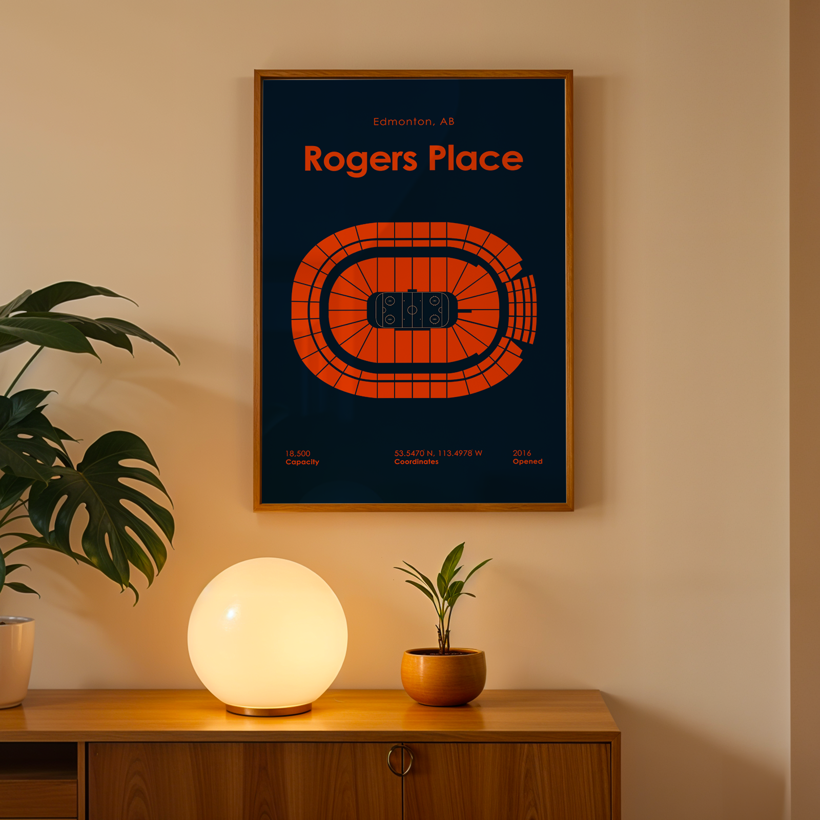 Framed poster of Rogers Place on a wall above a wooden cabinet with decorative items.