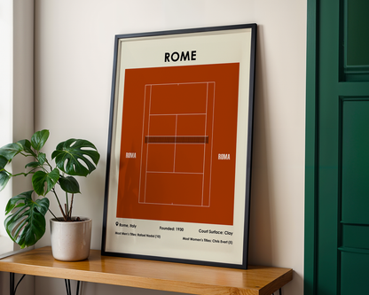 Framed poster of a tennis court design labeled 'Rome' on a wooden table with a plant.