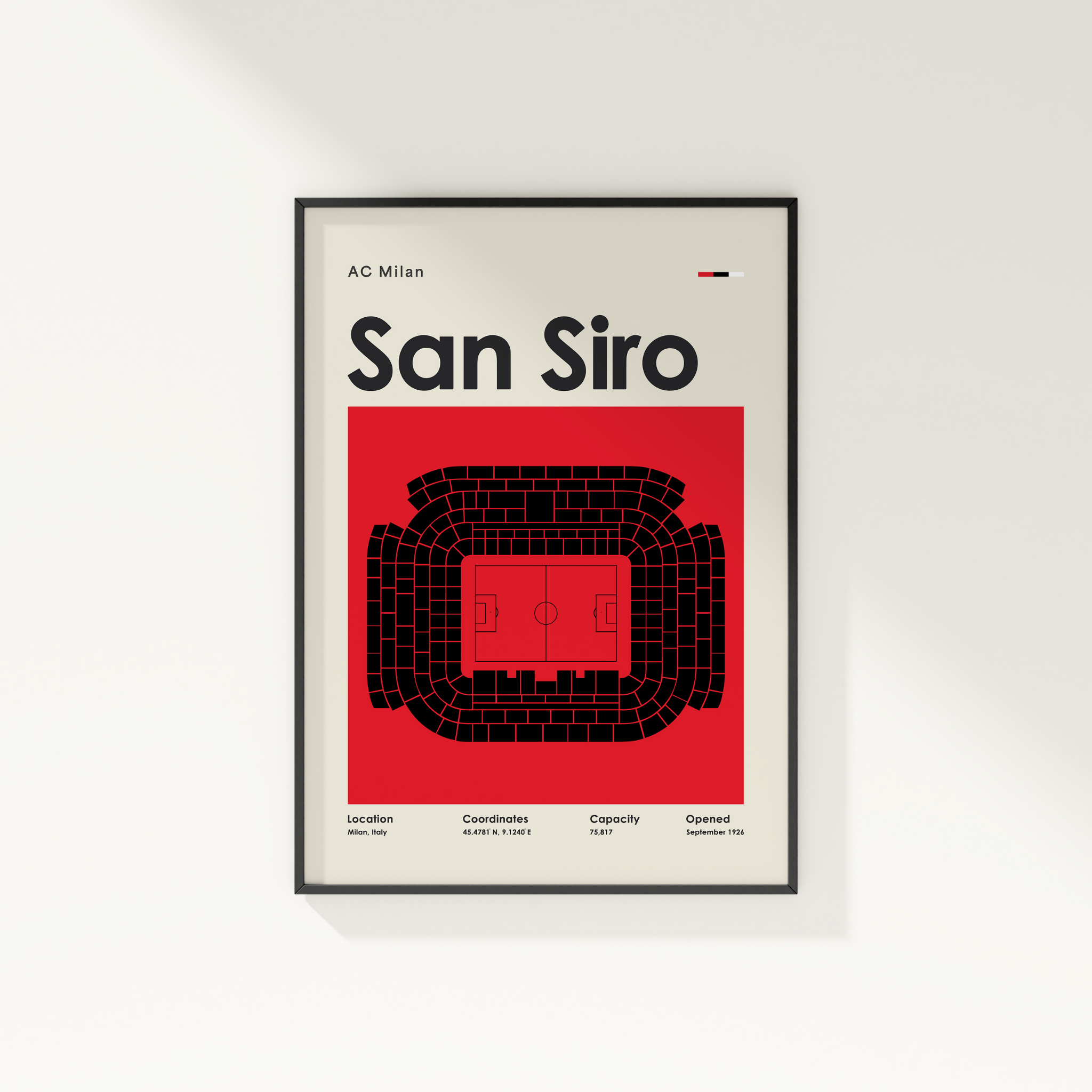 Framed poster of San Siro stadium with AC Milan logo on a white wall.