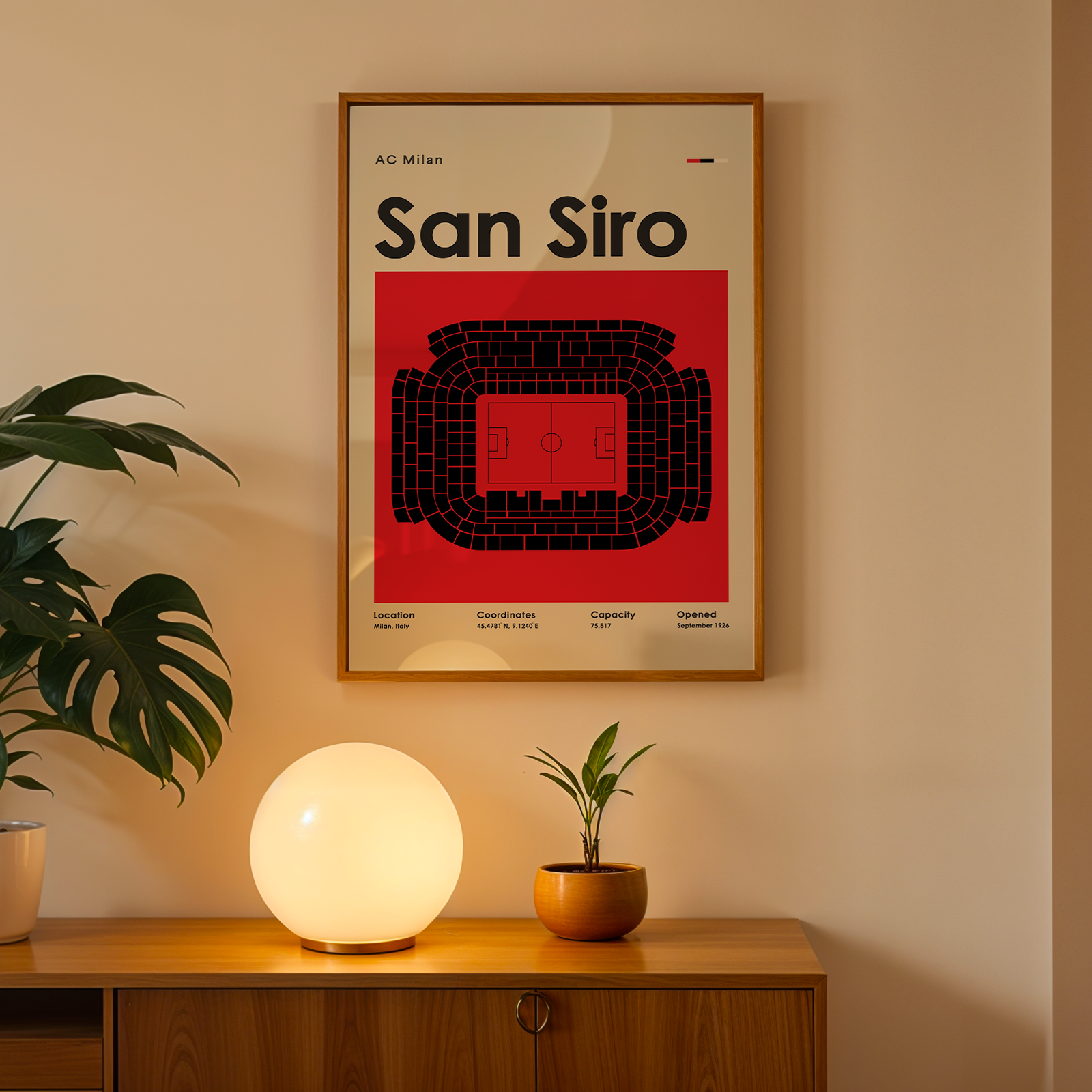 Poster of San Siro stadium on a wall above a wooden cabinet with decorative items.