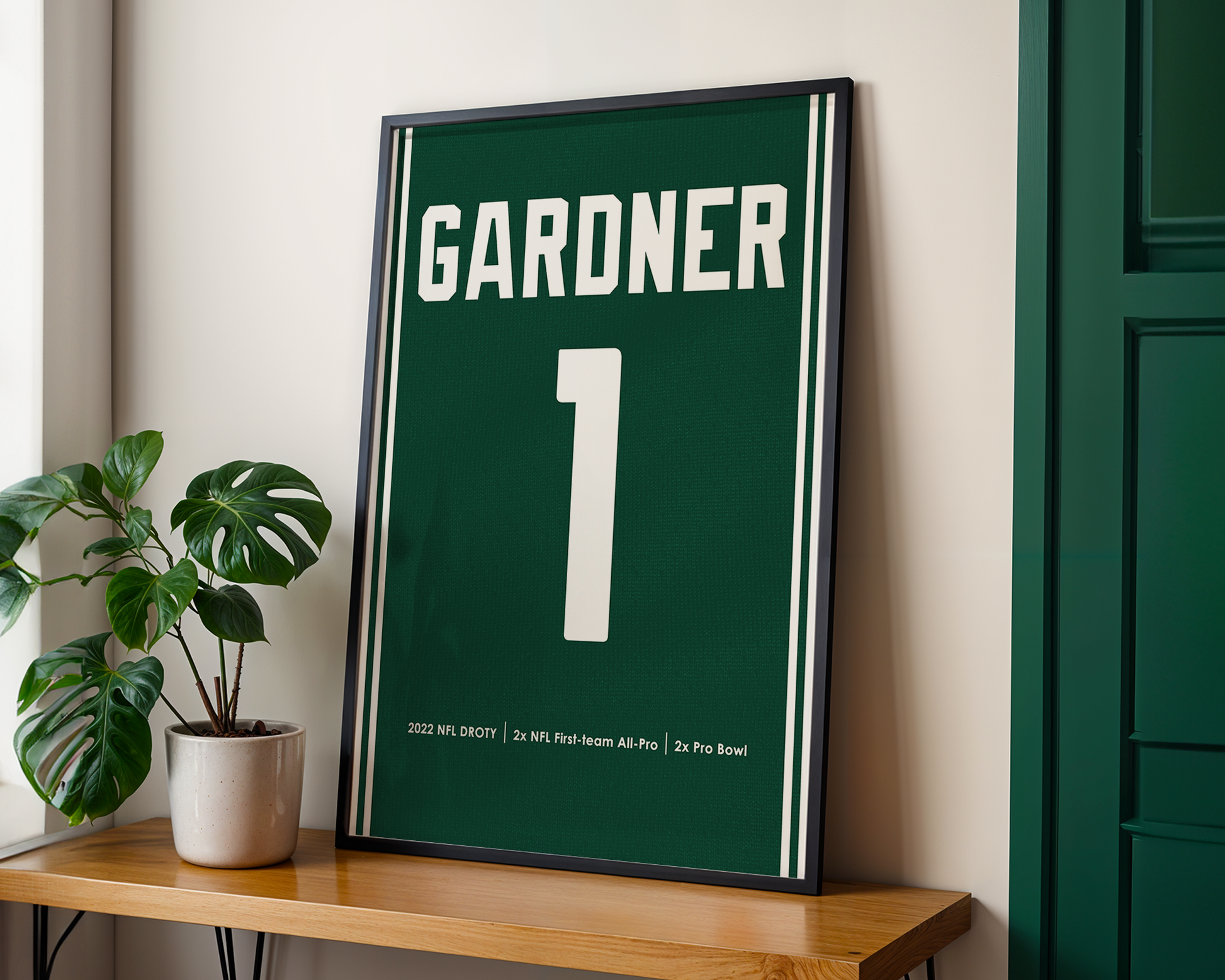 Framed sports jersey with 'Gardner' and number '1' on a wooden shelf.