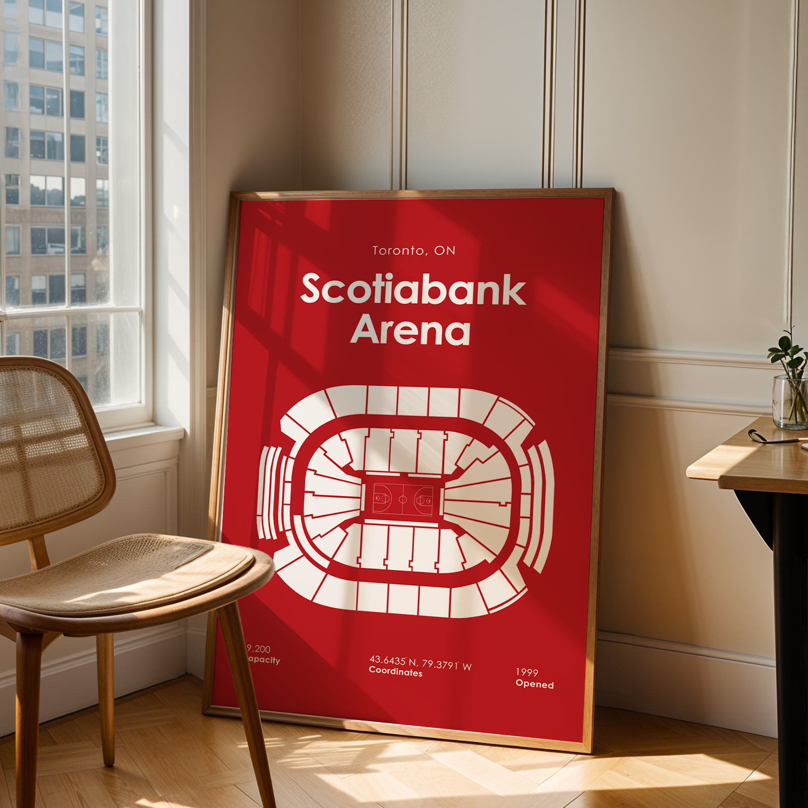 Framed poster of Scotiabank Arena in a room with a window and chair.