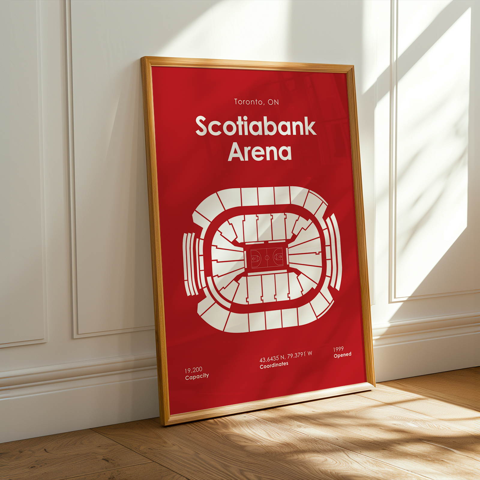 Framed poster of Scotiabank Arena on a wall with sunlight casting shadows.