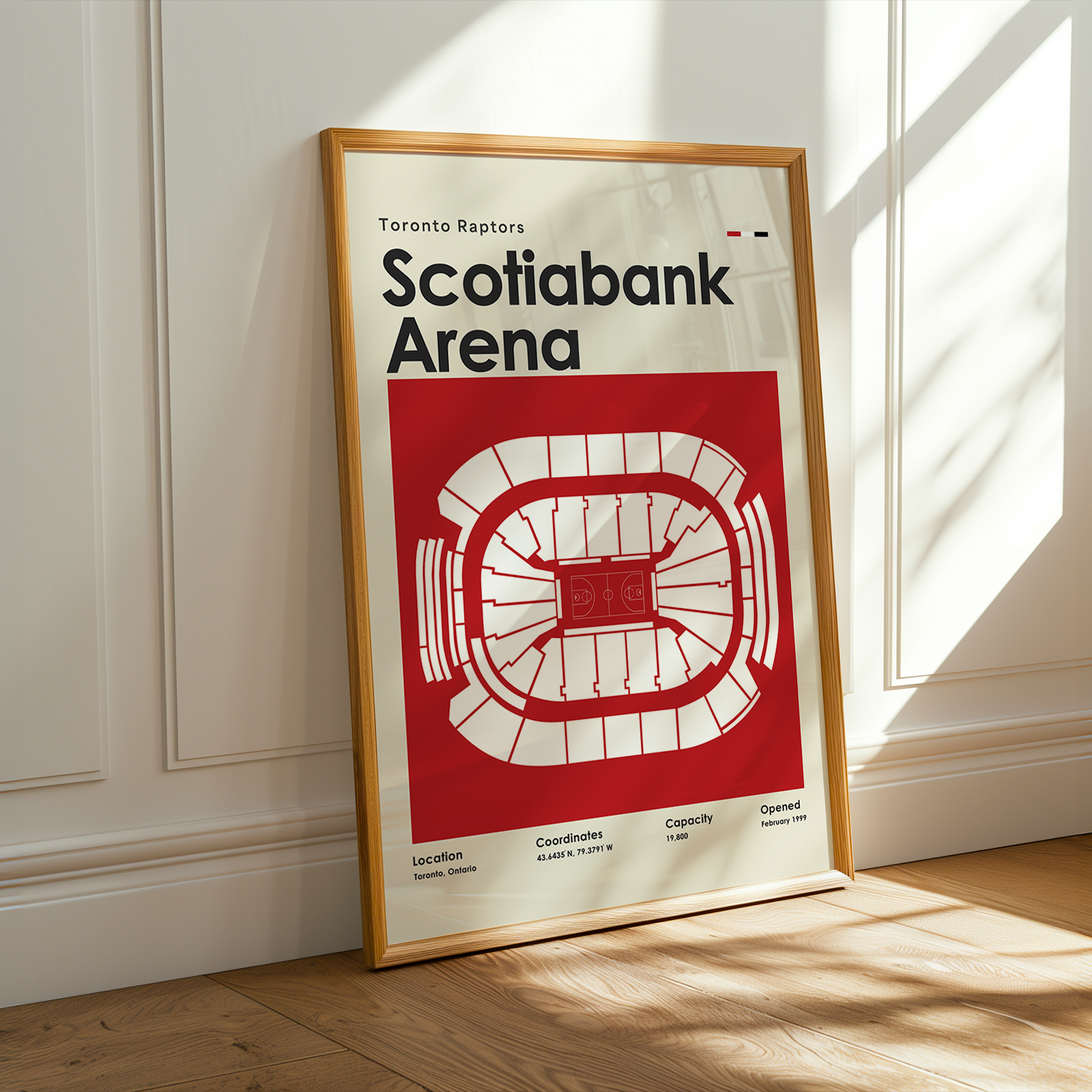Framed poster of Scotiabank Arena on a wall with sunlight casting shadows.