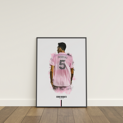 framed poster mockup of soccer player sergio busquets leaning on a white wall