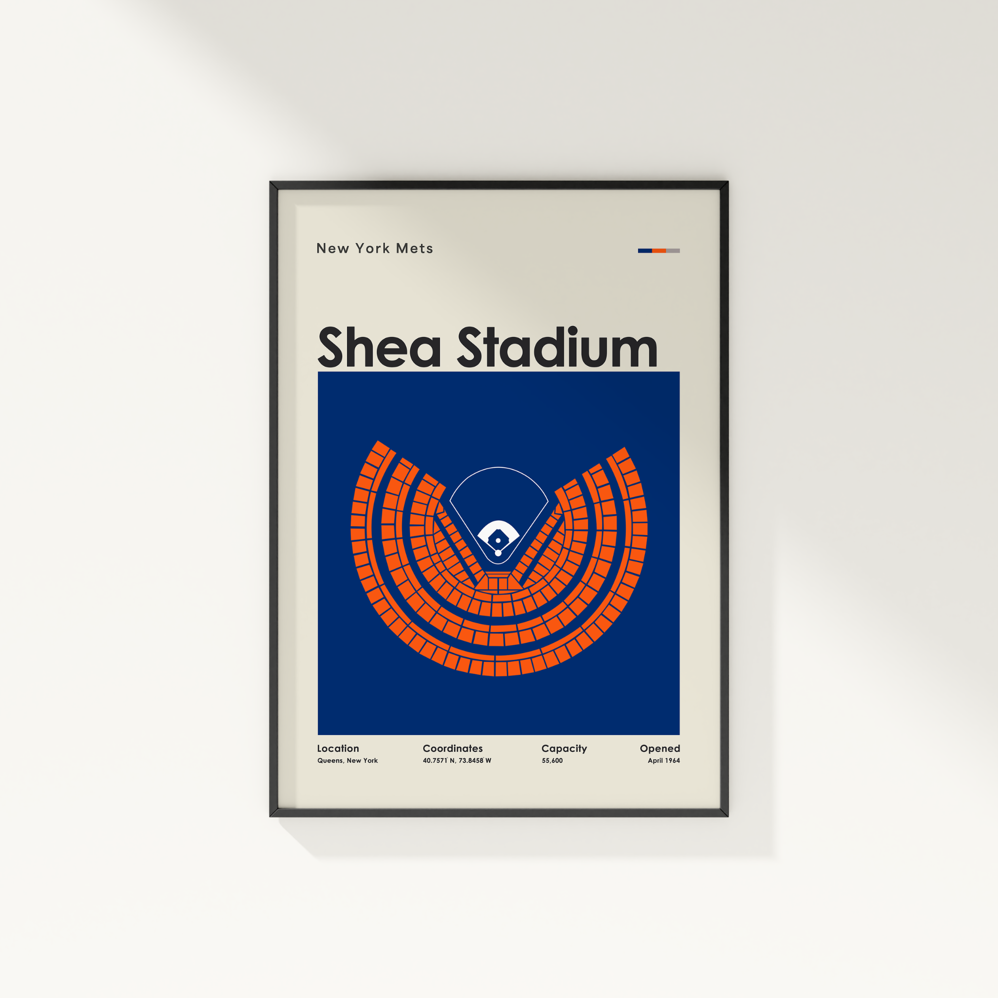 Framed poster of Shea Stadium with New York Mets branding on a white wall.