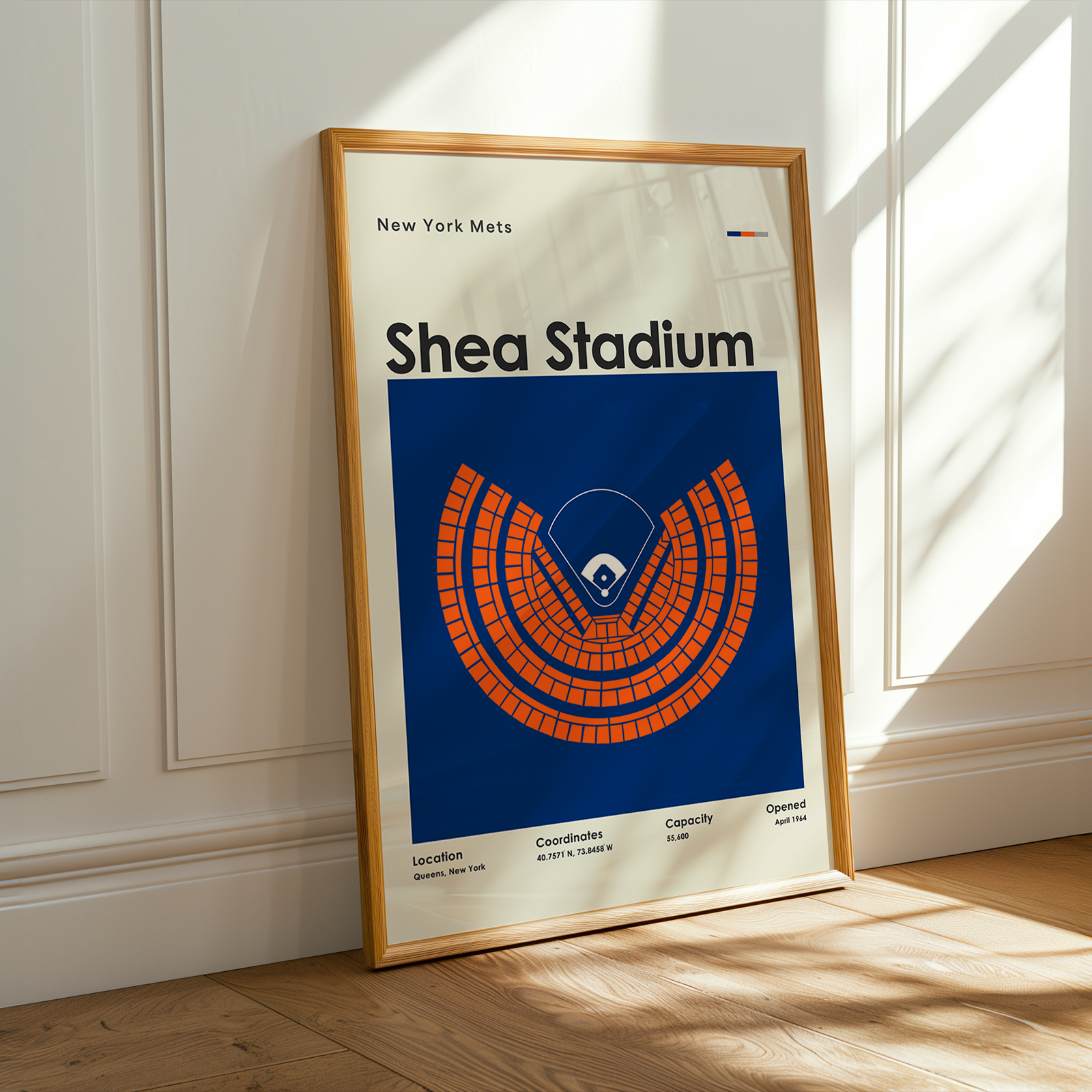 Framed poster of Shea Stadium with New York Mets logo on a wall.
