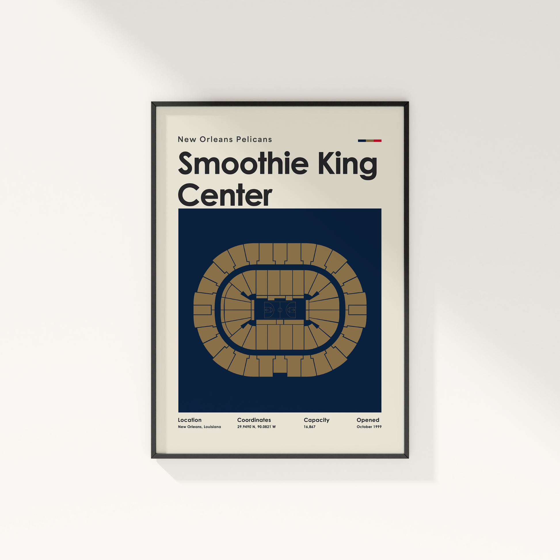 Framed poster of Smoothie King Center with New Orleans Pelicans text on a white wall.