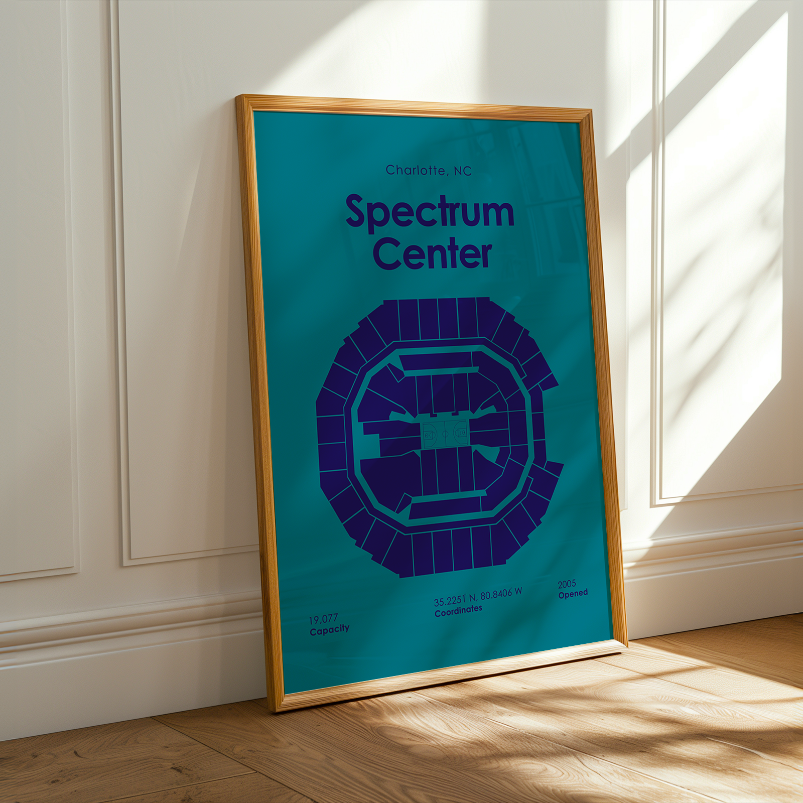 Framed poster of Spectrum Center in Charlotte, NC on a wall.