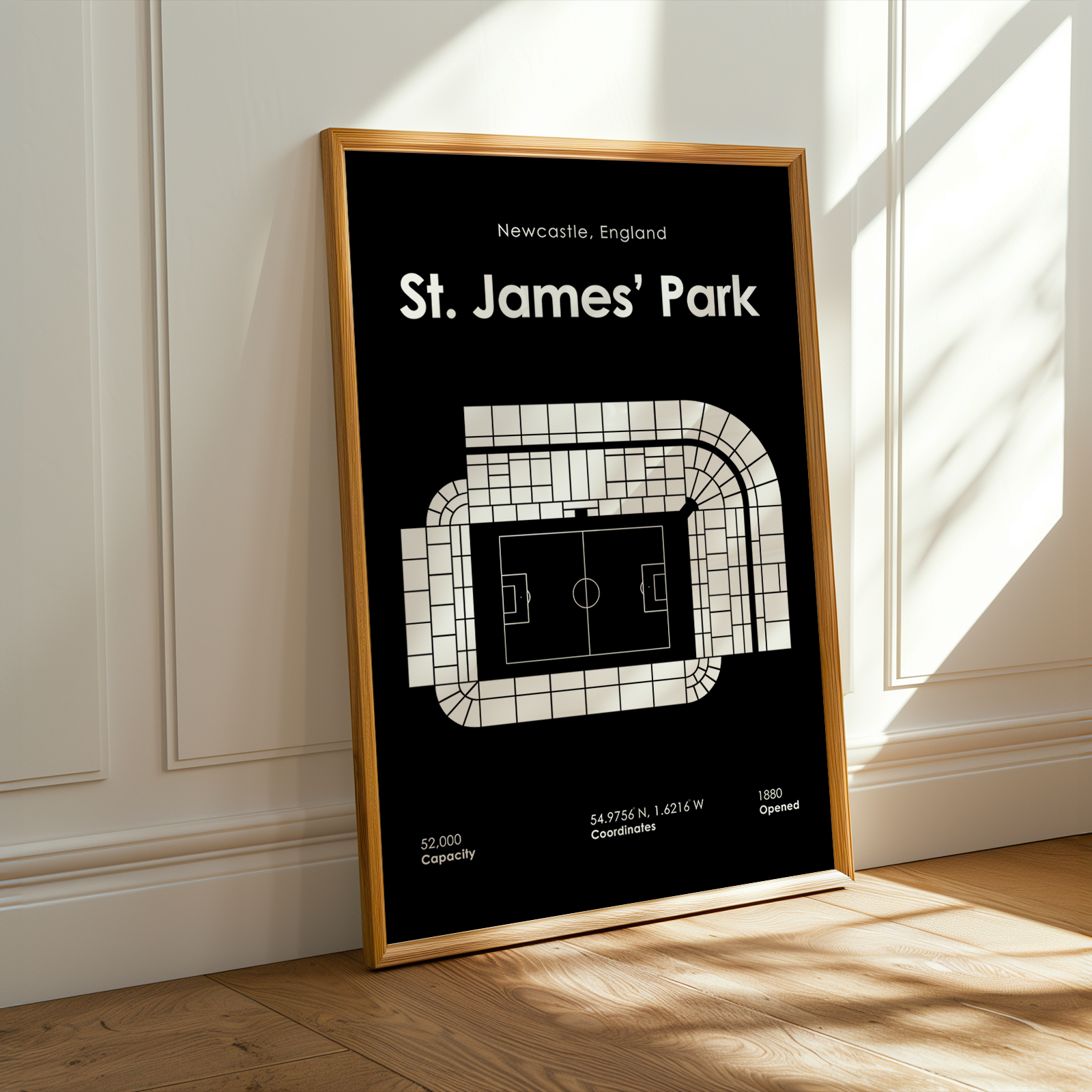 Framed poster of St. James' Park stadium layout on a wall.
