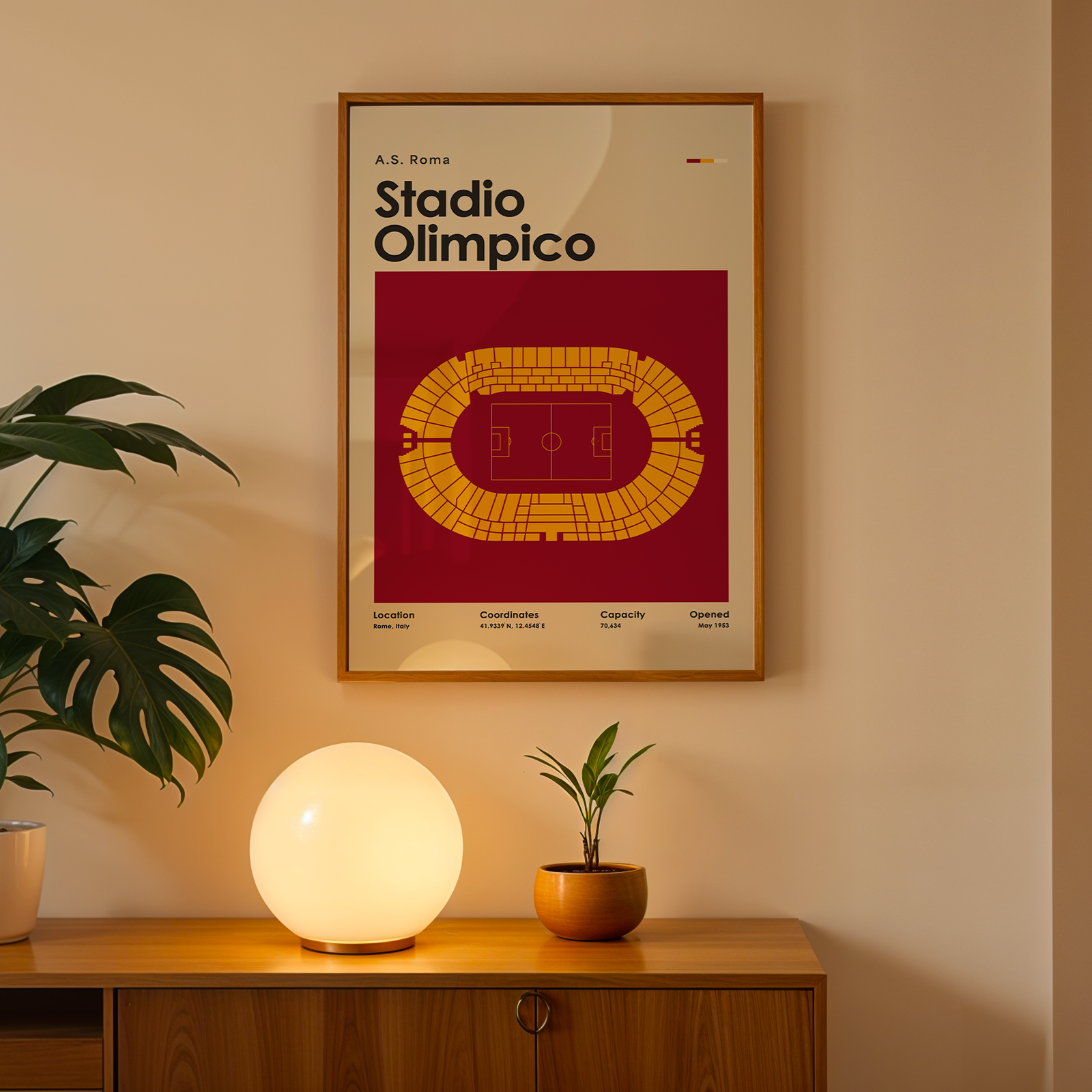 Framed poster of Stadio Olimpico on a wall above a wooden cabinet with decorative items.