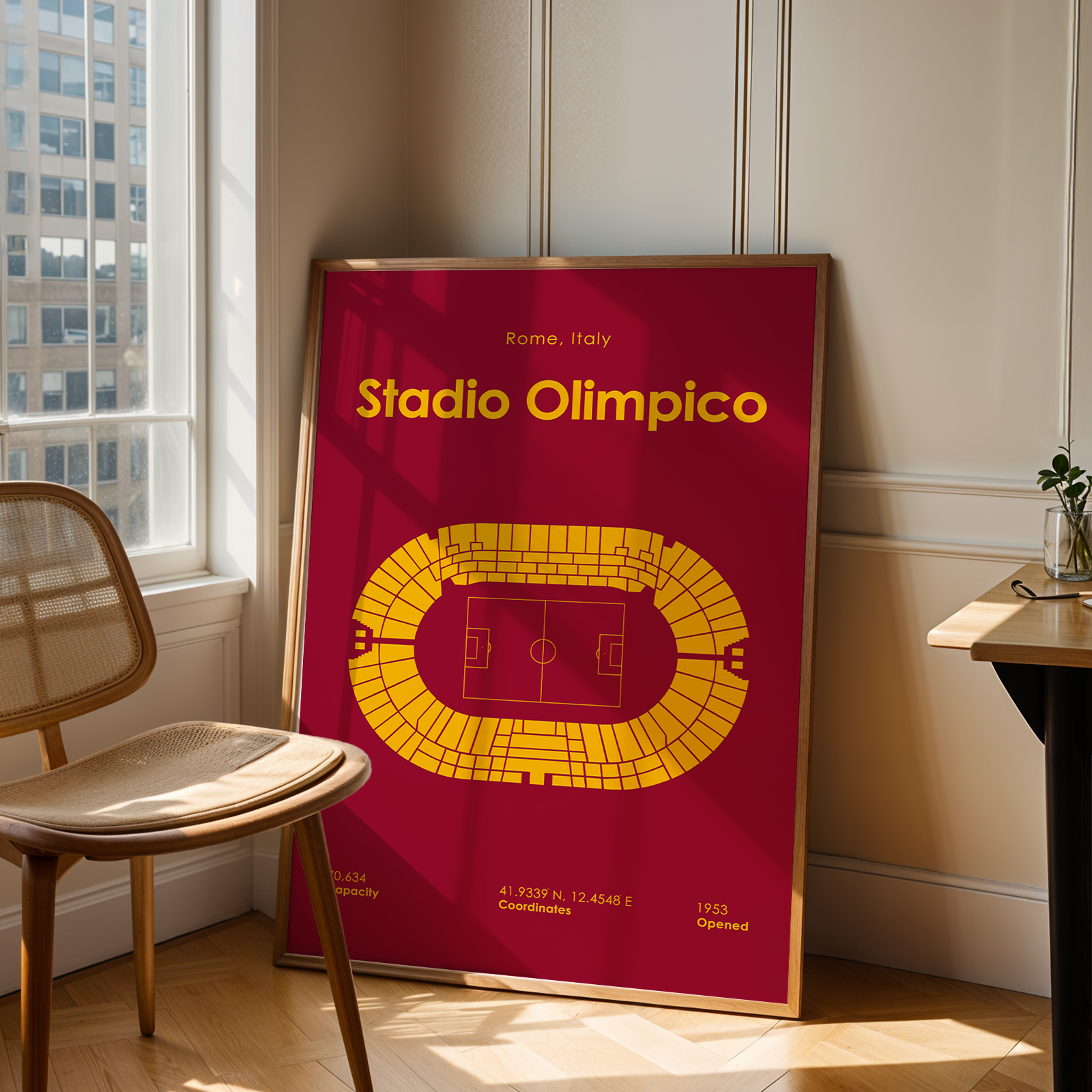 Poster of Stadio Olimpico in Rome, Italy, leaning against a wall in a room with a chair and window.