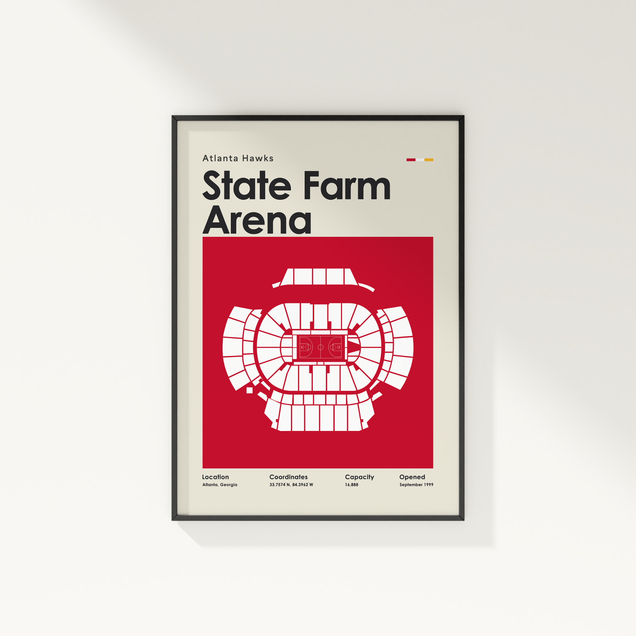 Framed poster of State Farm Arena with red and black design on a white wall.