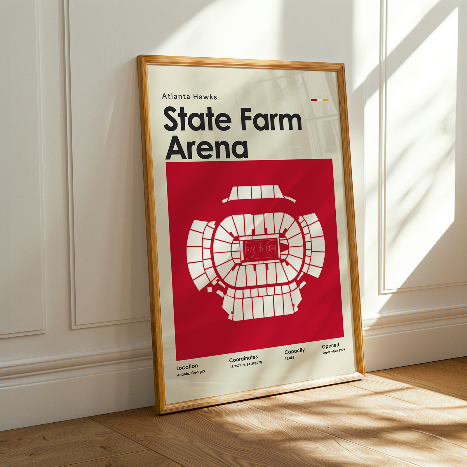 Framed poster of State Farm Arena with Atlanta Hawks branding on a wall.