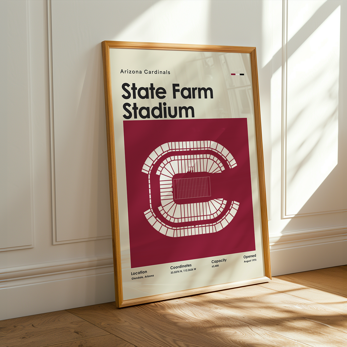 Framed poster of State Farm Stadium with Arizona Cardinals logo on a wall.