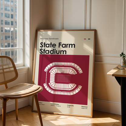 Framed poster of State Farm Stadium in a room with a chair and table.