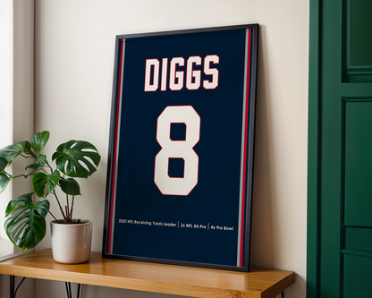 Framed sports jersey with 'DIGGS' and number '8' on a wooden shelf.