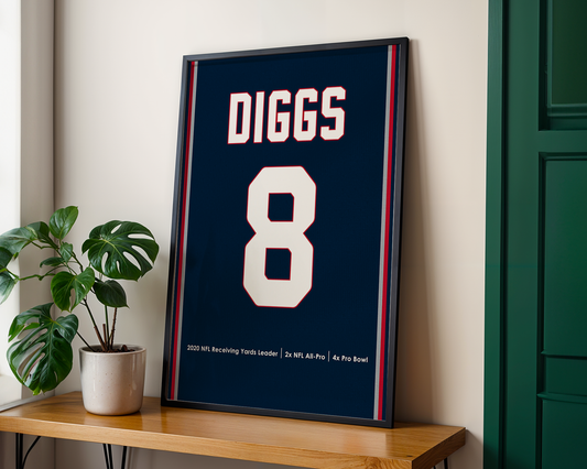 Framed sports jersey with 'DIGGS' and number '8' on a wooden shelf.