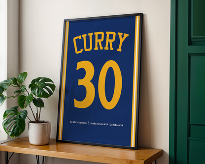 Framed sports jersey with 'Curry 30' on a wooden shelf next to a plant.
