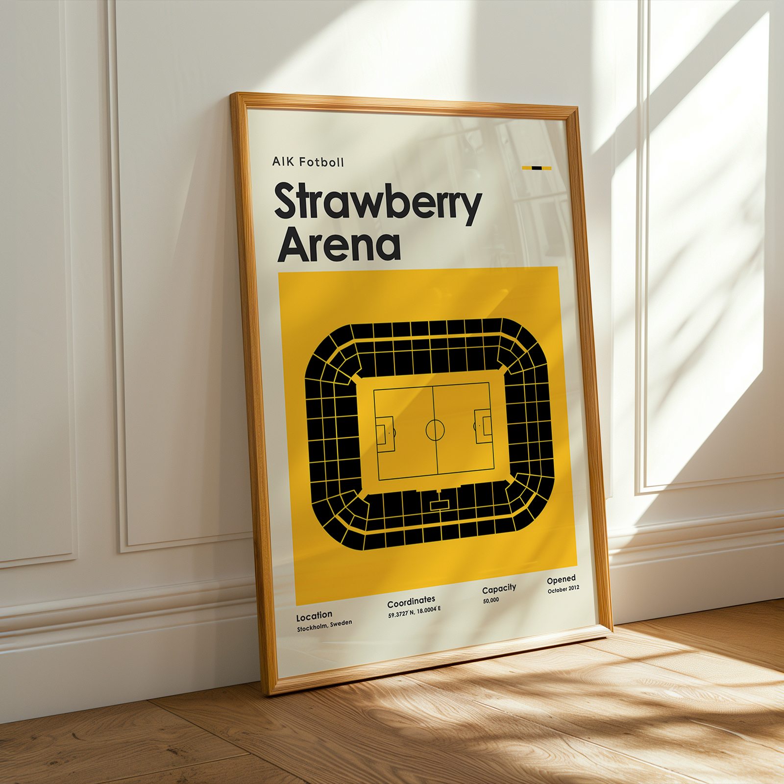 Framed poster of Strawberry Arena with a yellow and white design on a wall.