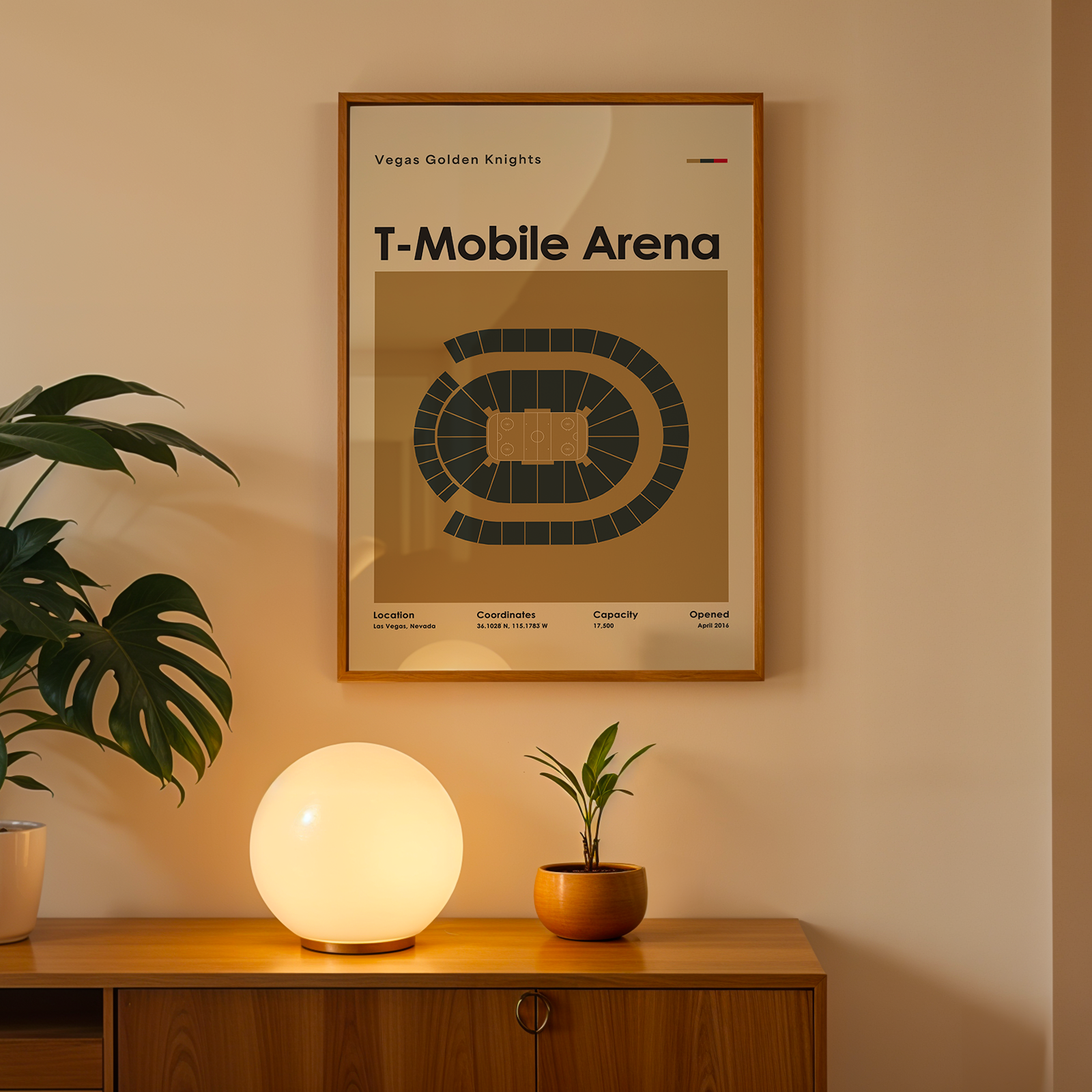 Framed poster of T-Mobile Arena on a wall above a wooden cabinet with decorative items.
