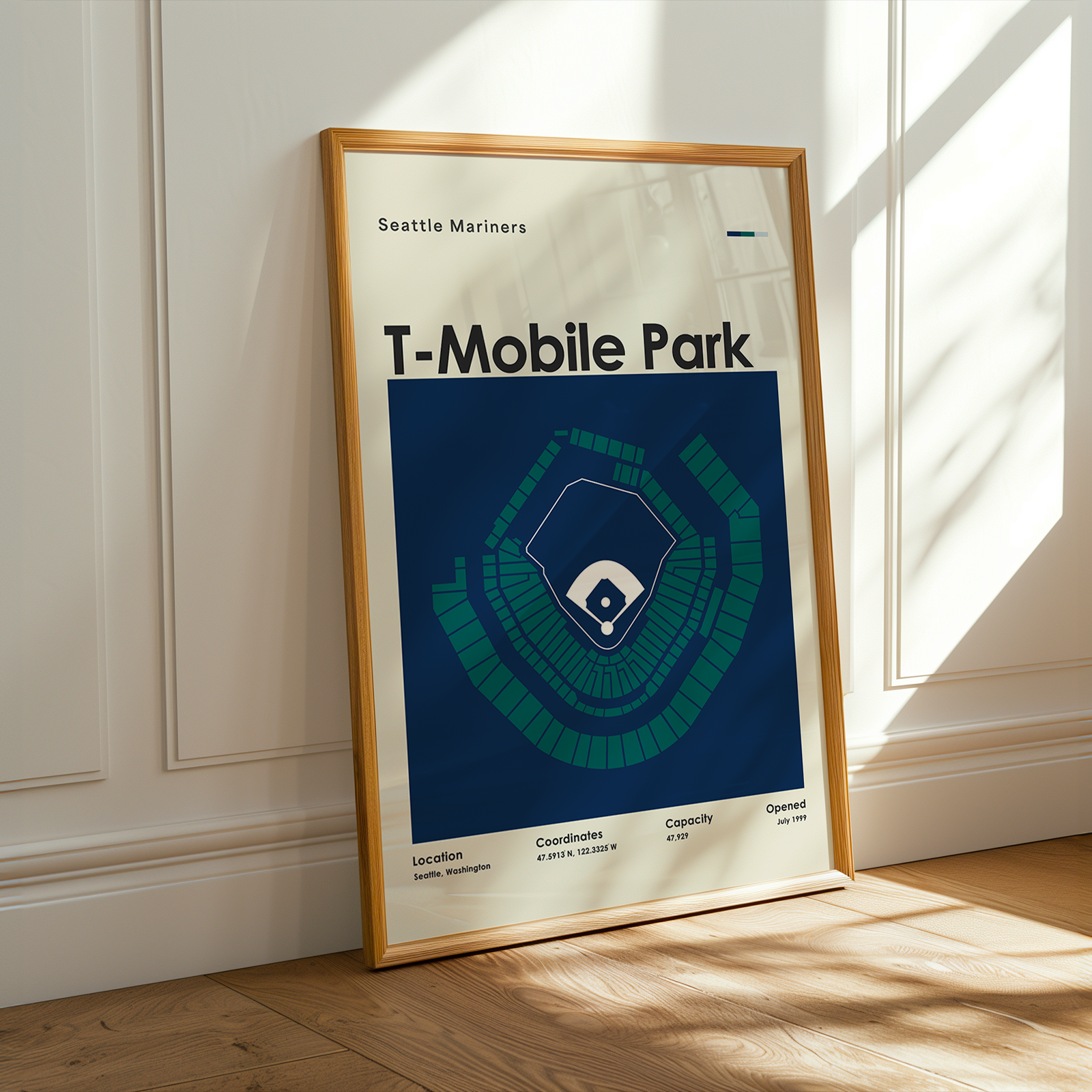 Framed poster of T-Mobile Park with Seattle Mariners branding on a wooden floor.
